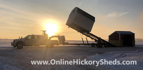 Hickory Shed being installed during a winter sunset